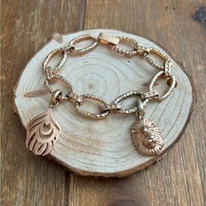 Kendra Scott RG charm bracelet. Lion & Feather charm included. Worn condition.